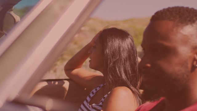 Young couple enjoying a summer road trip in a convertible car on a sunny day. Ideal for themes related to travel, adventure, relationships, and leisure. Perfect for advertisements or articles focusing on summer travel experiences and the joy of road trips.