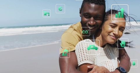 Happy Couple Embracing on Beach with Sustainability Icons Overlay