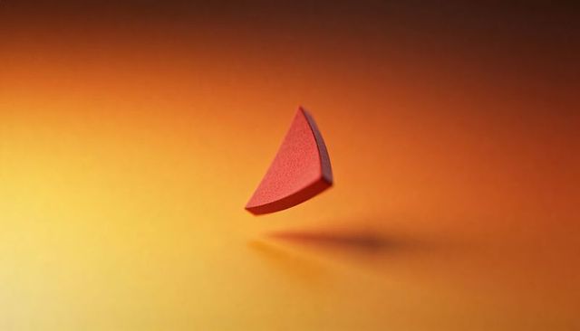 Floating red foam wedge on orange gradient — minimalist suspended still life