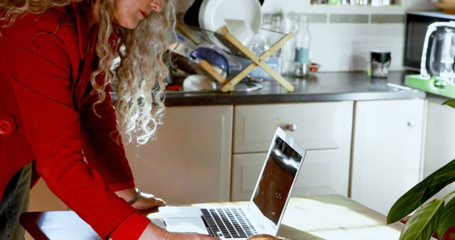 Person with Curly Hair Working on Laptop in Kitchen - Download Free Stock Images Pikwizard.com