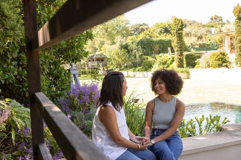 Mother and Daughter Bonding in Sunny Garden Patio