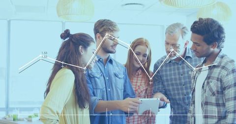 Team collaborating over tablet with line-graph overlays in bright modern office