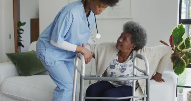 Caring african american female doctor helping senior african american female. senior healthcare, support and lifestyle.