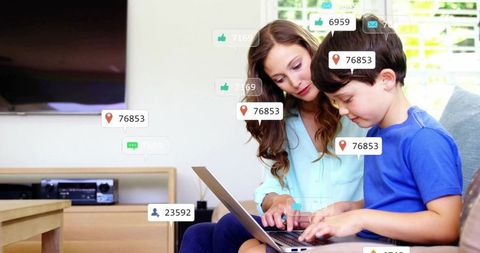 Mother and Son Bonding Over Laptop in Modern Living Room