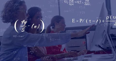 Female mentor guiding junior colleague at computer with scientific formulas overlay