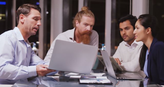 Diverse Business Team Collaborating during Late-Night Meeting - Download Free Stock Images Pikwizard.com