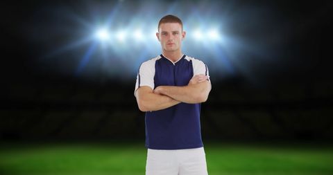Athlete standing confidently on illuminated sports field