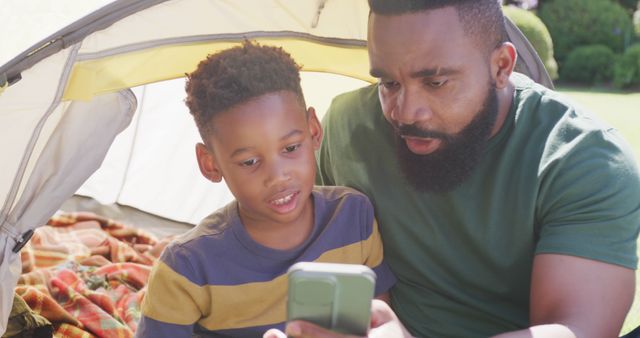 Father and Son Bonding While Camping with Smartphone - Download Free Stock Images Pikwizard.com