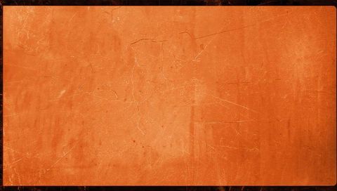 Worn orange panel showing fine cracks scratches and dust on dark framed weathered surface