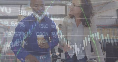 Business team collaborating amidst rising stock graphs