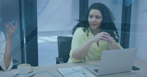 Professional Businesswoman in Meeting Room with Laptop and Charts