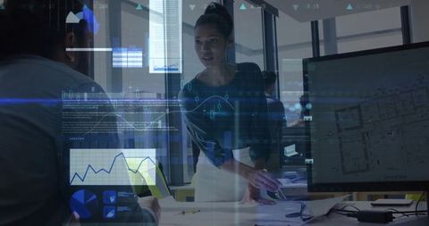 Female manager discussing project with data overlays in modern office