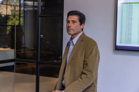 Professional man analyzing spreadsheet in modern office setting