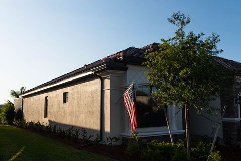 Suburban House with American Flag in Front Lawn at Sunset