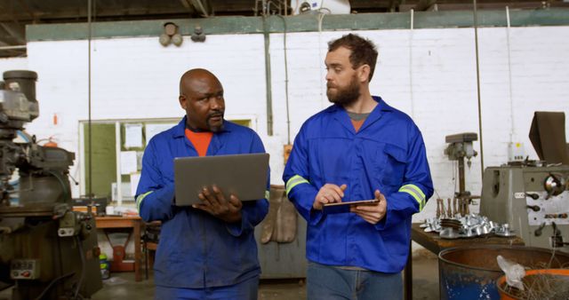 Teamwork in Mechanical Workshop: Collaborating Engineers Discussing Project - Download Free Stock Images Pikwizard.com