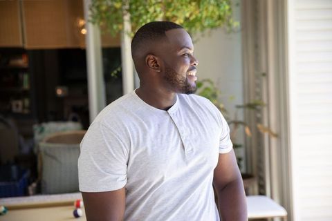 Smiling Man Enjoying Natural Light Indoors
