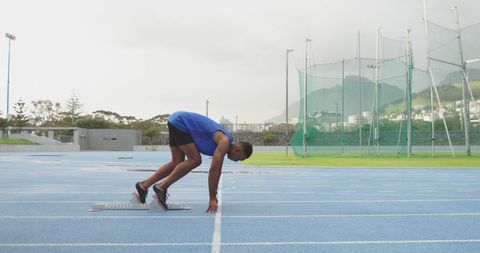 Track Athlete Preparing for Sprint on Outdoor Track - Download Free Stock Images Pikwizard.com