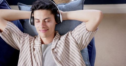 Relaxed Young Man Enjoying Music with Headphones at Home - Download Free Stock Images Pikwizard.com