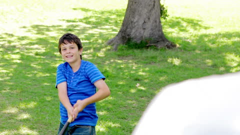 Smiling Boy Enjoys Playing Baseball in Sunny Park