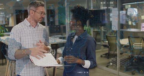 Professionals Discussing Strategies in Modern Office Environment