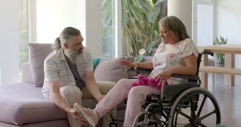 Senior Couple Engaging at Home, Elderly Woman in Wheelchair