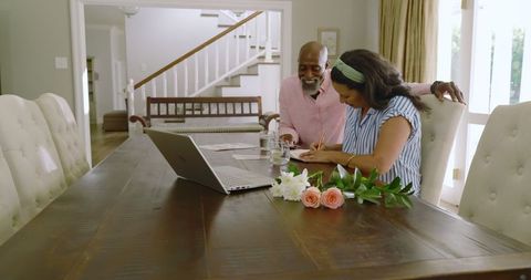 Senior diverse couple planning joyful celebration together