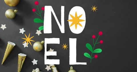 Noel lettering charcoal background gold baubles star o festive greenery elegant flatlay