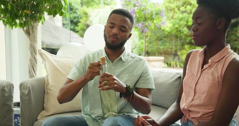Young Couple Enjoying Celebratory Drink Together at Home