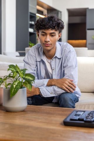 Pensive Man Relaxing in Modern Living Room Setting at Home