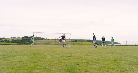 Youth Soccer Practice on Grass Field Demonstrating Teamwork