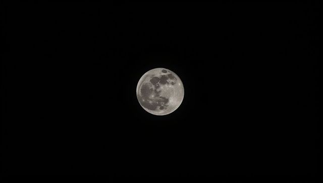 Detailed full moon in clear night sky with visible craters