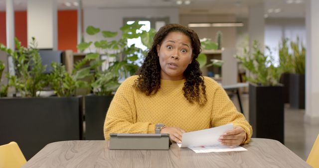 Woman in Office Holding Document Looking Surprised - Download Free Stock Images Pikwizard.com