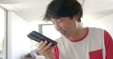 Asian Student Talking on Smartphone in Casual Setting