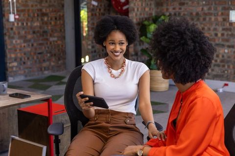 Diverse coworkers collaborating in modern office lounge