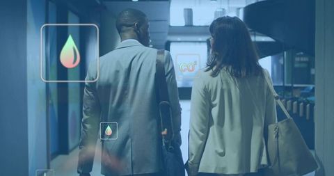 Walking professionals in modern office corridor carrying bags while displaying CO2 and energy icons