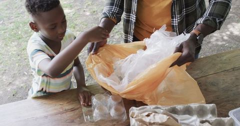African American Father Son Bonding Recycling Outdoors Park
