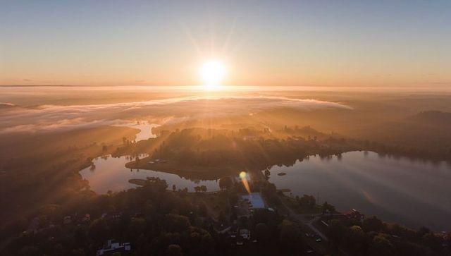 Rural Lakeside Town Bathing in Golden Sunrise Mist Over Twin Lakes