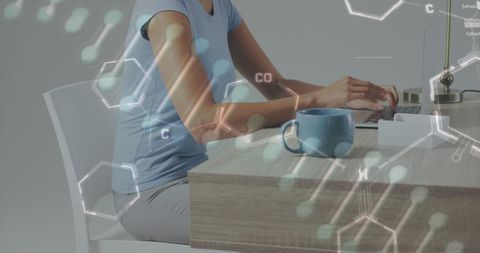 Woman Working on Laptop with Digital Chemical Overlay