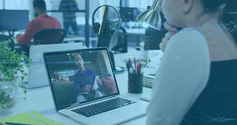Professional Engaged in Virtual Meeting at Modern Office Desk