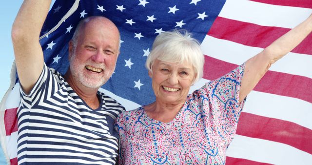 Senior couple holding American flag together