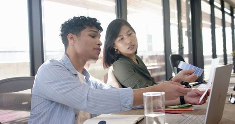 Diverse Coworkers Collaborating on Color Palette and Designs