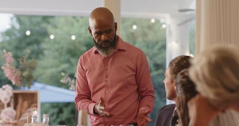 Man delivering passionate speech at wedding reception