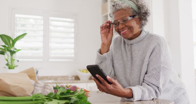 Senior Woman Using Smartphone in Modern Kitchen - Download Free Stock Images Pikwizard.com