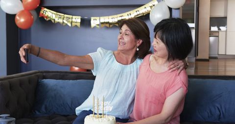 Senior friends taking selfie at birthday celebration