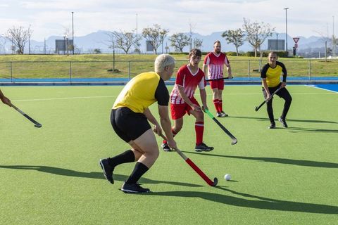 Teamwork in Action: Field Hockey Players Competing Intensely Outdoors
