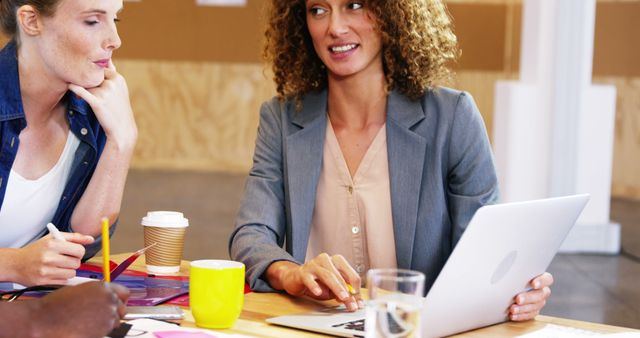 Businesswoman Collaborating With Colleague in Office Setting - Download Free Stock Images Pikwizard.com