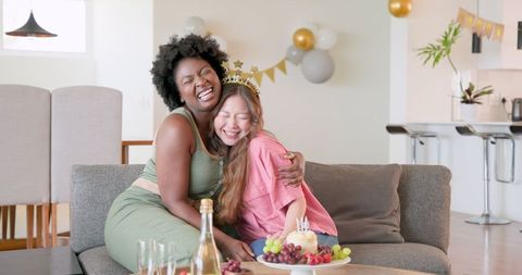 Joyful Couple Celebrating Birthday at Home with Cake and Candles