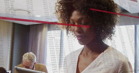 Woman Reviewing Code in Collaborative Office Environment