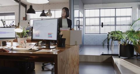 Businesswoman Relocating with Office Supplies, Modern Work Environment