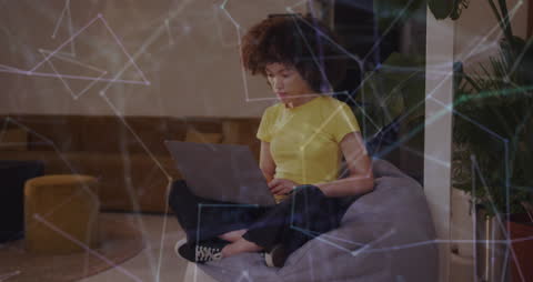 Focused Woman Using Laptop in Modern Digital Environment